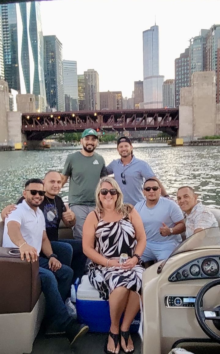 the grout medic of north chicago team on a boat in the river